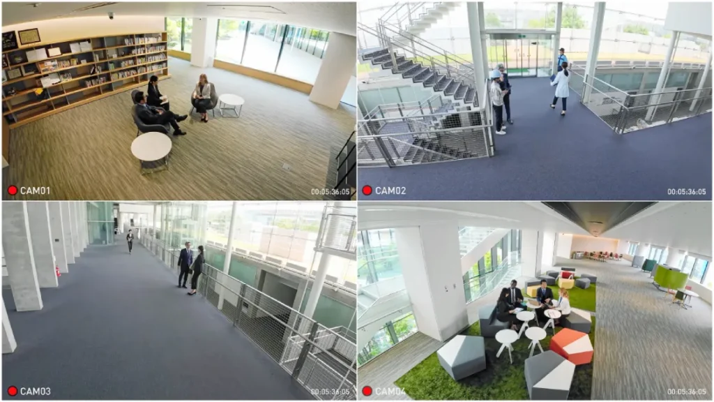 Four-camera CCTV system displaying live footage of lobbies, stairways, and common areas inside an office building