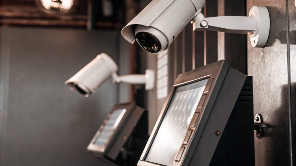 High-tech CCTV and access control system with biometric authentication and integrated security cameras monitoring a secure facility entrance.