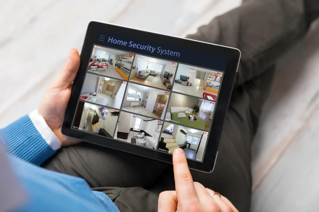 Homeowner monitoring Home Security Systems Phoenix cameras on a tablet