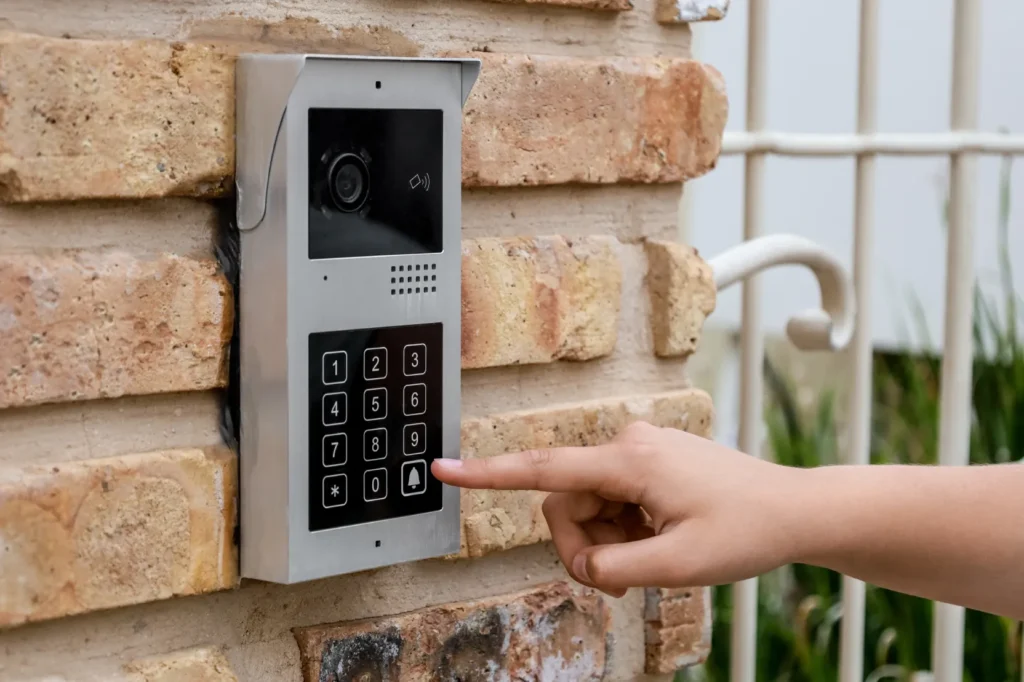 Arizona Intercom Systems video doorbell with keypad access control mounted on brick wall at residential gate entry