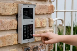 Arizona Intercom Systems video doorbell with keypad access control mounted on brick wall at residential gate entry