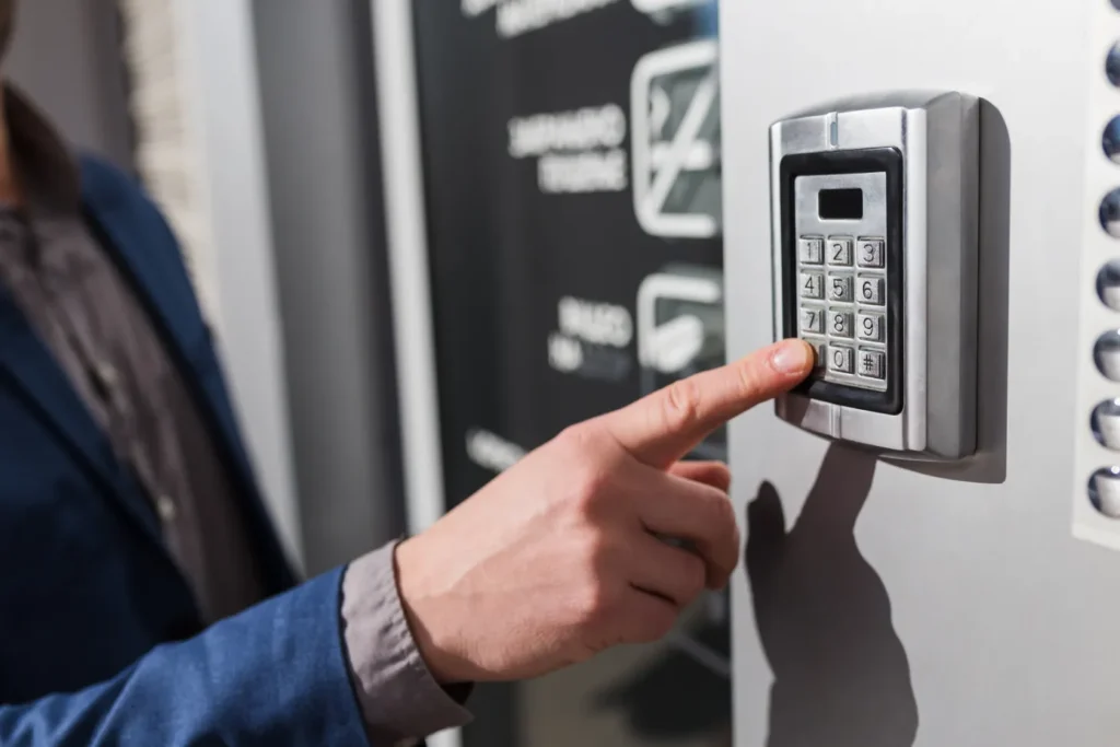 Person entering a code on a commercial access control systems keypad